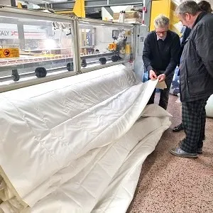 Exceptional wool duvet on machine with people inspecting